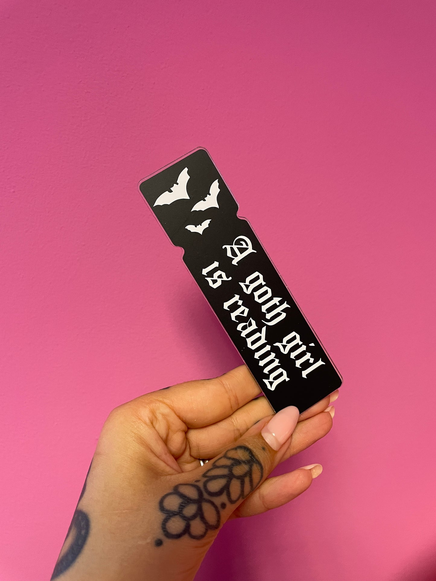 A goth girl is reading acrylic bookmark accessory